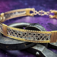 Elevate any ensemble effortlessly with the luxurious DEKKA Collar. The collar exhibits a unique and feminine style. Its open lattice work and both smooth and hand-twisted accents give it a striking elegance that can take you from dusk to dawn and garner attention wherever you go. Crafted with a luxurious combination of Art Deco-inspired sterling silver and accents in your choice of precious metals. 