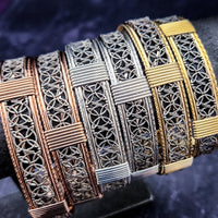 The Dekka Bracelet boasts luxurious open lattice areas of sterling silver with metal accents.