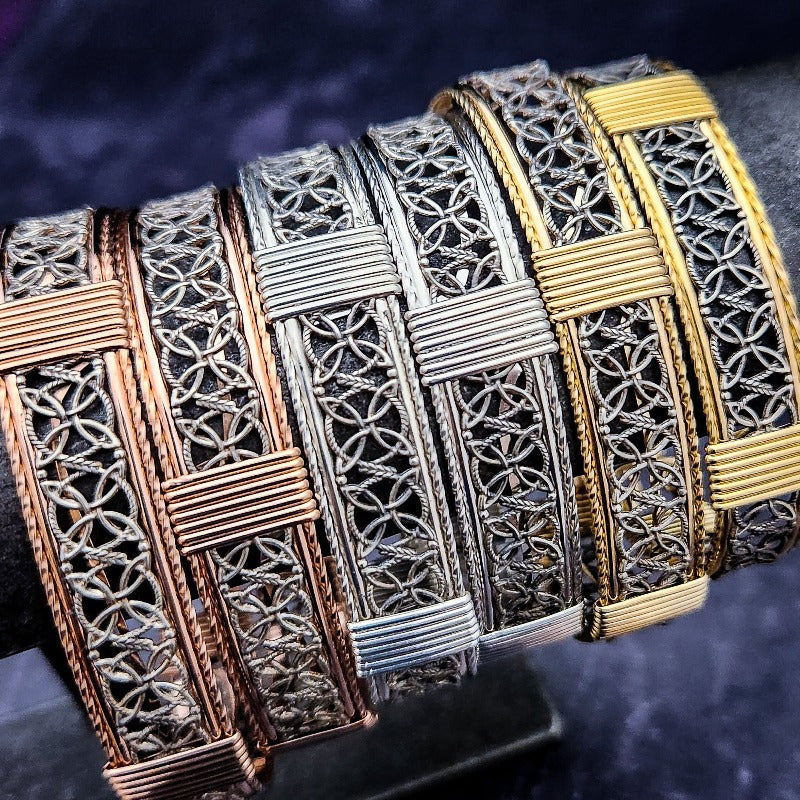 The Dekka Bracelet boasts luxurious open lattice areas of sterling silver with metal accents.