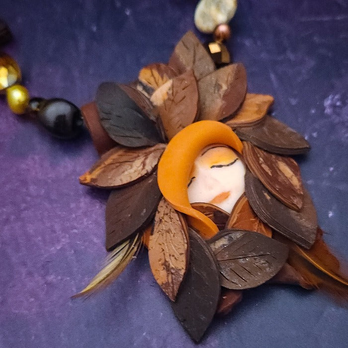 FOREST FAIRIES are ONE OF A KIND Artisan Necklaces. A sweet little fairy is caught napping in her nest of leaves. Each is a one of a kind piece of wearable art with her own unique look and personality. The faces are hand-painted and then surrounded by hand-cut leaves and collected beads, gemstones and sculpted treasures.