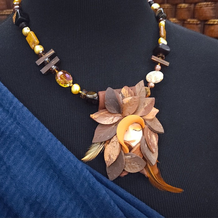 FOREST FAIRIES are ONE OF A KIND Artisan Necklaces. A sweet little fairy is caught napping in her nest of leaves. Each is a one of a kind piece of wearable art with her own unique look and personality. The faces are hand-painted and then surrounded by hand-cut leaves and collected beads, gemstones and sculpted treasures.