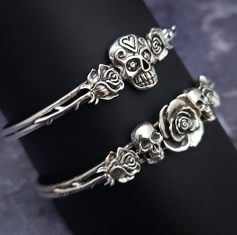 Embrace the unpredictable and add a touch of darkness to your fashion with our Goth Garden Cuffs. Lots of Skulls, Roses, Serpents and such. Let your spooky shine! By My Secret Heart Studios