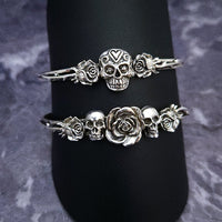 Embrace the unpredictable and add a touch of darkness to your fashion with our Goth Garden Cuffs. Lots of Skulls, Roses, Serpents and such. Let your spooky shine! By My Secret Heart Studios