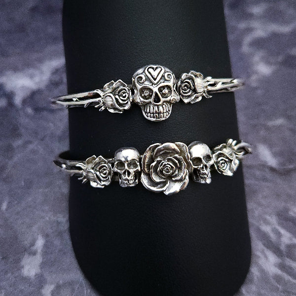 Embrace the unpredictable and add a touch of darkness to your fashion with our Goth Garden Cuffs. Lots of Skulls, Roses, Serpents and such. Let your spooky shine! By My Secret Heart Studios
