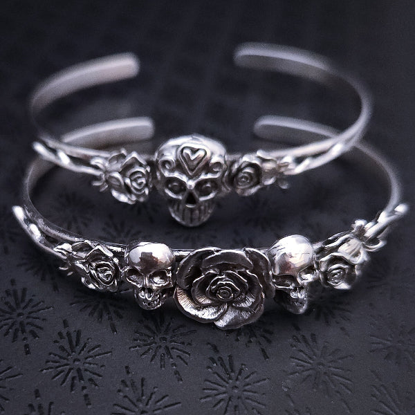 Embrace the unpredictable and add a touch of darkness to your fashion with our Goth Garden Cuffs. Lots of Skulls, Roses, Serpents and such. Let your spooky shine! By My Secret Heart Studios