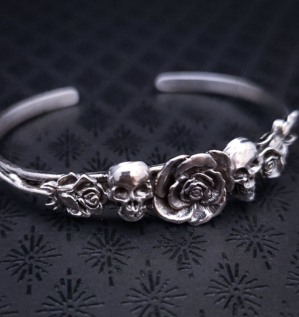 Embrace the unpredictable and add a touch of darkness to your fashion with our Goth Garden Cuffs. Lots of Skulls, Roses, Serpents and such. Let your spooky shine! By My Secret Heart Studios