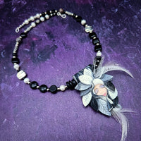 FOREST FAIRIES are ONE OF A KIND Artisan Necklaces. A sweet little fairy is caught napping in her nest of leaves. Each is a one of a kind piece of wearable art with her own unique look and personality. The faces are hand-painted and then surrounded by hand-cut leaves and collected beads, gemstones and sculpted treasures. By Studio Navarri
