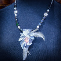 FOREST FAIRIES are ONE OF A KIND Artisan Necklaces. A sweet little fairy is caught napping in her nest of leaves. Each is a one of a kind piece of wearable art with her own unique look and personality. The faces are hand-painted and then surrounded by hand-cut leaves and collected beads, gemstones and sculpted treasures. By Studio Navarri