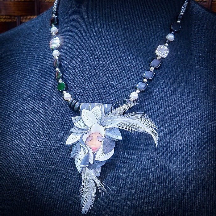 FOREST FAIRIES are ONE OF A KIND Artisan Necklaces. A sweet little fairy is caught napping in her nest of leaves. Each is a one of a kind piece of wearable art with her own unique look and personality. The faces are hand-painted and then surrounded by hand-cut leaves and collected beads, gemstones and sculpted treasures. By Studio Navarri