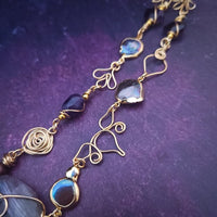 Feel empowered and beautiful wearing our exquisite Zasha Gemstone Collar, meticulously crafted with 14K gold-filled and stunning Amethyst gemstones. The hand-sculpted wire details, reminiscent of delicate flower petals, make this piece truly one of a kind. With a touch of elegance and sophistication, this statement collar will turn heads. 