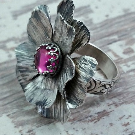 Take a journey to a summer cottage, gracefully adorned with climbing roses, clematis and wisteria. Invoke a feeling of warmth and tranquility with this sterling silver and pink sapphire COTTAGE ROSE Ring.