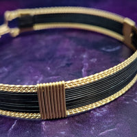 Be daring and adventurous with your style with the AMARI Collar. Crafted from a luxurious combination of blackened sterling silver and surrounded by hand-twisted accents, this collar will take you from dusk till dawn with an eye-catching elegance that will turn heads wherever you go.  Studio Navarri.