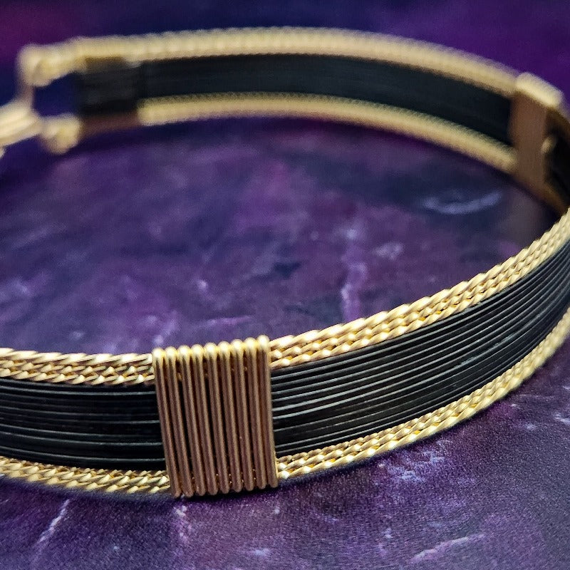 Be daring and adventurous with your style with the AMARI Collar. Crafted from a luxurious combination of blackened sterling silver and surrounded by hand-twisted accents, this collar will take you from dusk till dawn with an eye-catching elegance that will turn heads wherever you go.  Studio Navarri.