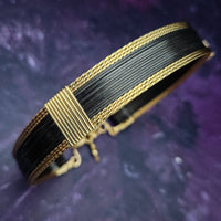 Be daring and adventurous with your style with the AMARI Collar. Crafted from a luxurious combination of blackened sterling silver and surrounded by hand-twisted accents, this collar will take you from dusk till dawn with an eye-catching elegance that will turn heads wherever you go.  Studio Navarri.
