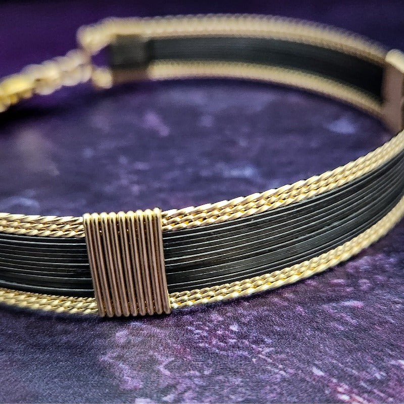 Be daring and adventurous with your style with the AMARI Collar. Crafted from a luxurious combination of blackened sterling silver and surrounded by hand-twisted accents, this collar will take you from dusk till dawn with an eye-catching elegance that will turn heads wherever you go.  Studio Navarri.
