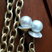 THE 5th AVENUE LARIAT is bold and dramatic, and will definitely get some attention. A large circular disc attached to gold Brittanium chain with both wafer and large freshwater pearls. Simply place the circle where you want it, wrap the chain around your neck and slide the ends thru the circle. Voila! Instant Fashionista!