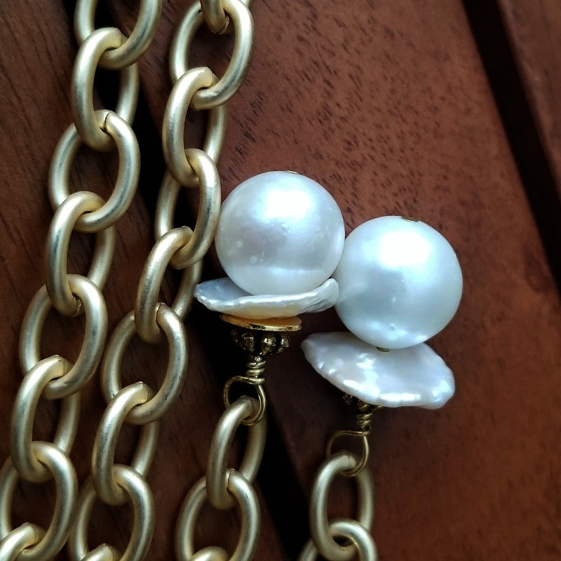 THE 5th AVENUE LARIAT is bold and dramatic, and will definitely get some attention. A large circular disc attached to gold Brittanium chain with both wafer and large freshwater pearls. Simply place the circle where you want it, wrap the chain around your neck and slide the ends thru the circle. Voila! Instant Fashionista!