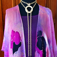 THE 5th AVENUE LARIAT is bold and dramatic, and will definitely get some attention. A large circular disc attached to gold Brittanium chain with both wafer and large freshwater pearls. Simply place the circle where you want it, wrap the chain around your neck and slide the ends thru the circle. Voila! Instant Fashionista!