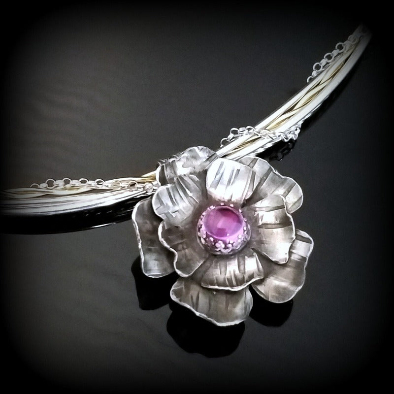 This stunning, handmade Rose of Aphrodite Pendant, crafted in sterling silver, symbolizes love and beauty, but also evokes enduring strength.