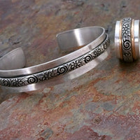 Wild Flower Wide Sterling Silver Cuff Bracelet. Luxurious solid sterling silver in a nice and heavy 19 gauge, the cuff measures approx. 3/4" wide with a floral center soldered onto the cuff. Oxidized to add depth and detail.