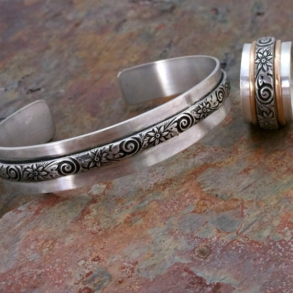 Wild Flower Wide Sterling Silver Cuff Bracelet. Luxurious solid sterling silver in a nice and heavy 19 gauge, the cuff measures approx. 3/4" wide with a floral center soldered onto the cuff. Oxidized to add depth and detail.
