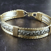 The ‘ZUZY’ collection, hand crafted in a flirty floral pattern of sterling silver and wire wrapped with gold accents.