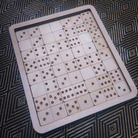 A wooden domino game board with multiple light wood domino tiles arranged on a dark patterned surface.