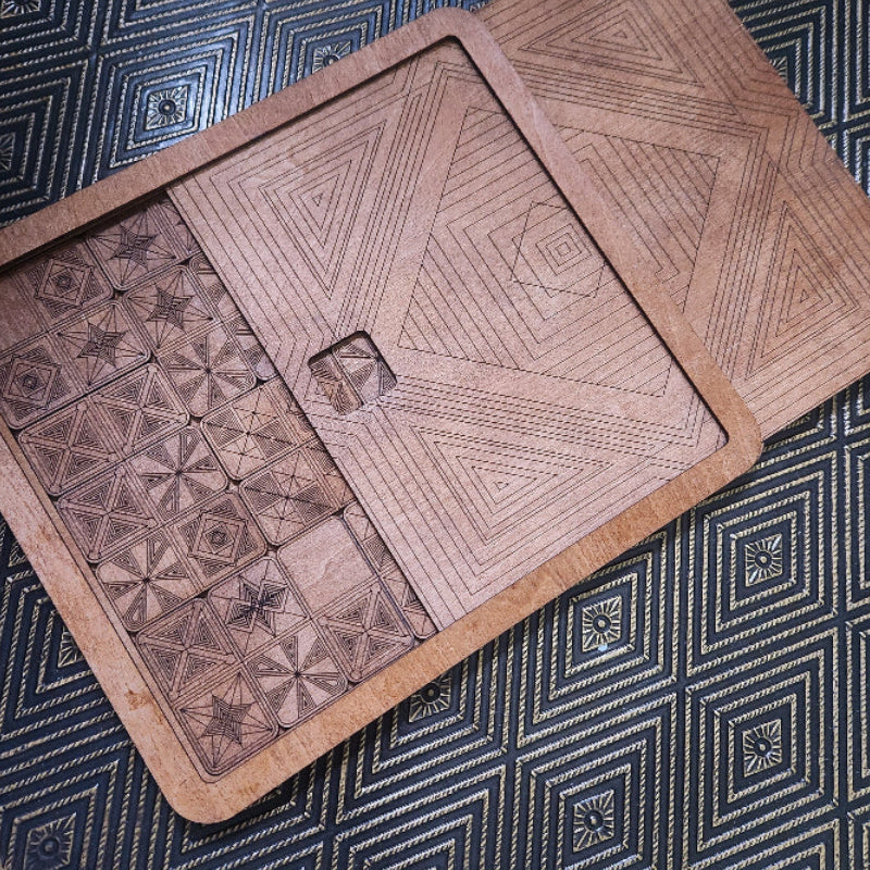 Laser Cut Wooden Dominoes Game with Slide Top Storage Box, with geometric patterns on a textured surface. By Studio Navarri