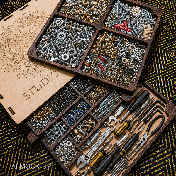 An open wooden organizer tray filled with assorted hardware, screws, nuts, washers, and tools including wrenches, pliers, and screwdrivers, arranged on a patterned black-and-gold surface. A second closed wooden lid with engraved artwork and the word STUDIO is partially visible.