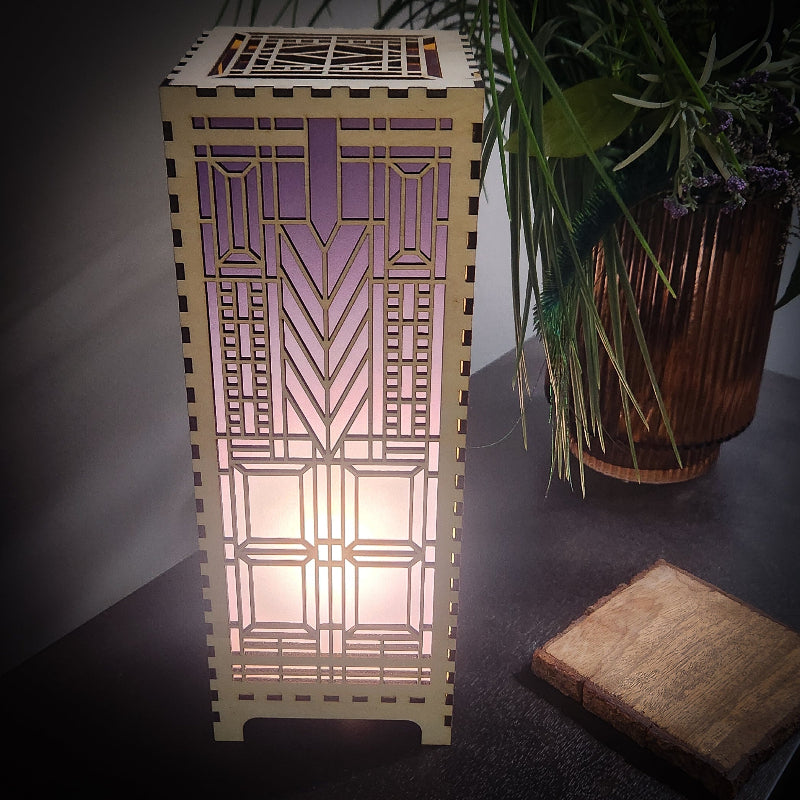Domara LED lamp with Frank Lloyd Wright inspired Arts and Craftsman styled lamp on a dark surface next to a plant