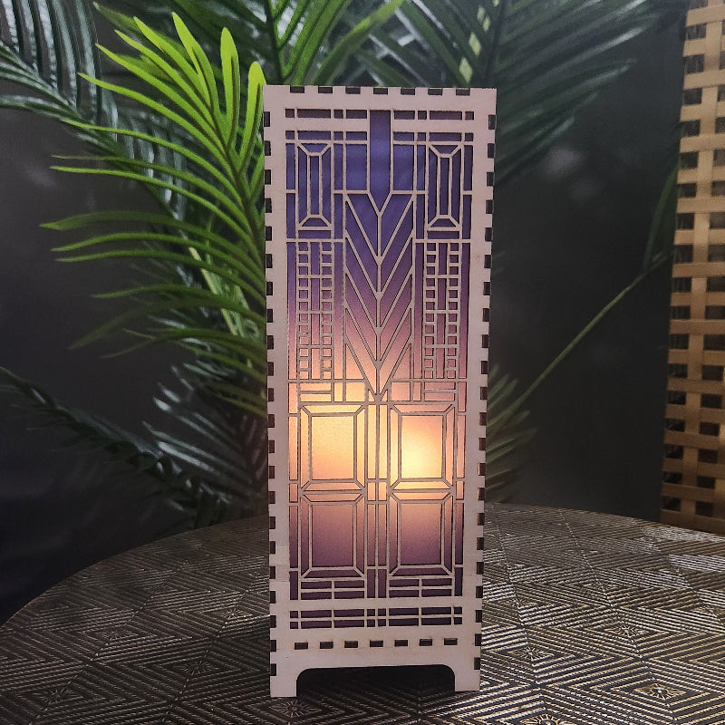 Domara LED lamp with Frank Lloyd Wright inspired Arts and Craftsman styled lamp on a dark surface next to a plant

