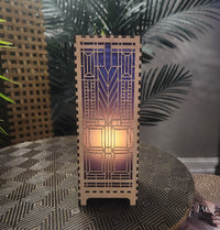 Domara LED lamp with Frank Lloyd Wright inspired Arts and Craftsman styled lamp on a dark surface next to a plant