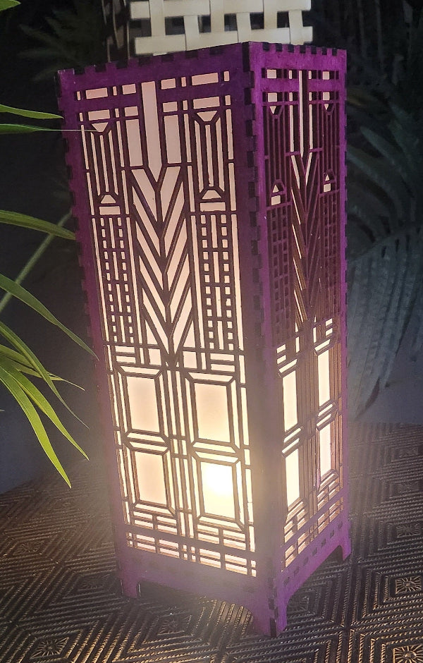 Decorative purple lamp with geometric pattern on a dark background