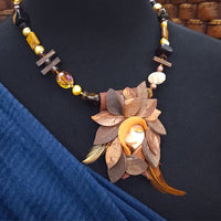 FOREST FAIRIES are ONE OF A KIND Artisan Necklaces. A sweet little fairy is caught napping in her nest of leaves. Each is a one of a kind piece of wearable art with her own unique look and personality. The faces are hand-painted and then surrounded by hand-cut leaves and collected beads, gemstones and sculpted treasures. 