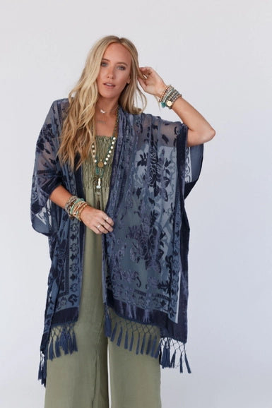 Everyone loves a great kimono- This elevated style features a dreamy velvet and mesh blend that will catch anyone's eye! The tassel details add extra movement for a fun and flirty look. Style with your favorite basics for an easy head to toe outfit!