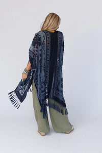 Everyone loves a great kimono- This elevated style features a dreamy velvet and mesh blend that will catch anyone's eye! The tassel details add extra movement for a fun and flirty look. Style with your favorite basics for an easy head to toe outfit!