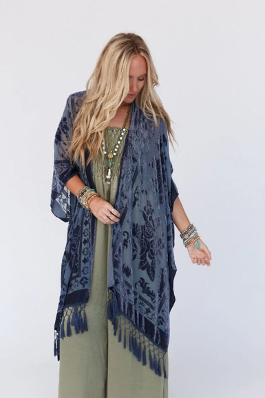 Everyone loves a great kimono- This elevated style features a dreamy velvet and mesh blend that will catch anyone's eye! The tassel details add extra movement for a fun and flirty look. Style with your favorite basics for an easy head to toe outfit!