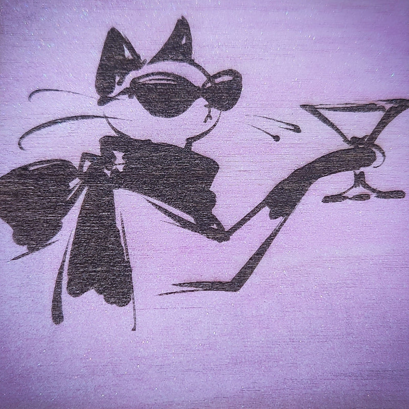 Vogue Feline in a suit holding a martini glass on a textured pink background