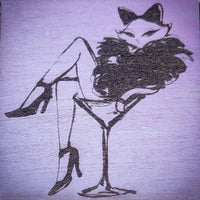 Artistic illustration of a woman with cat ears sitting on a martini glass against a textured pink background.