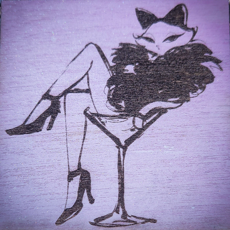 Artistic illustration of a woman with cat ears sitting on a martini glass against a textured pink background.