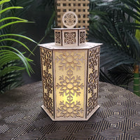 Decorative lantern with snowflake patterns on a textured surface with plants in the background