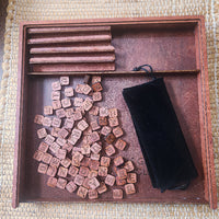 Wooden scrabble tiles with a black bag on a wooden tray