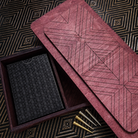 Teak stained cribbage game box, open to reveal a black cardholder and gold pen.