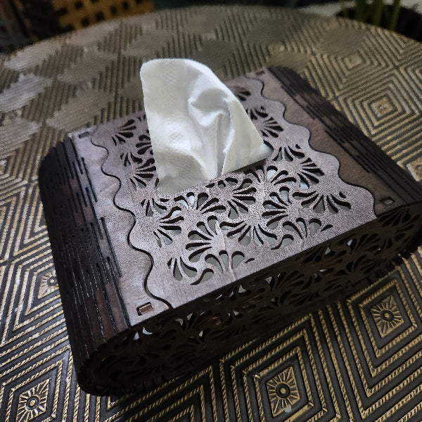 Decorative tissue box with a white tissue on a patterned surface