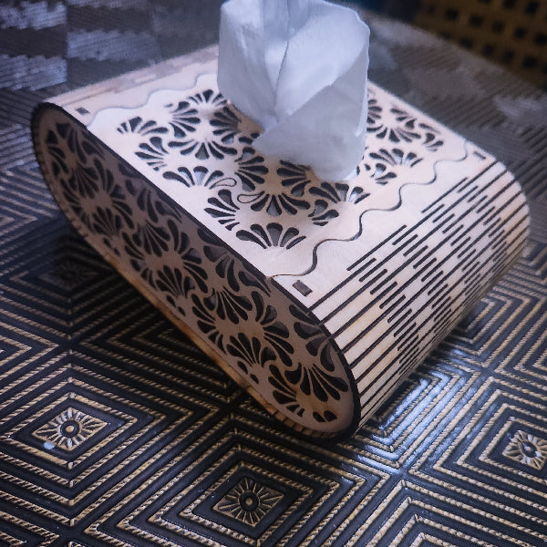 Decorative tissue box with intricate patterns on a textured surface