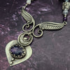 Let your inner goddess shine with this one-of-a-kind Velavee Angel Necklace! Exquisitely crafted from sterling silver and the rare Charoite gemstone, the necklace features an angel wing and an inverted fan shaped medallion for a stunning, unique look. Ready to ship, shine brighter than ever with this divine accessory!