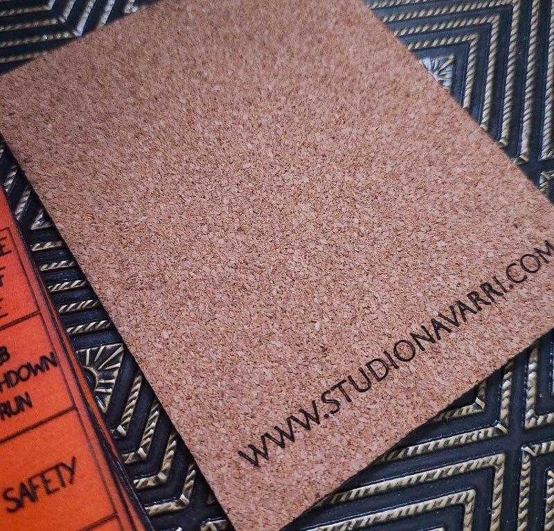 A square brown textured sample card with the printed website URL 'WWW.STUDIONAVARRI.