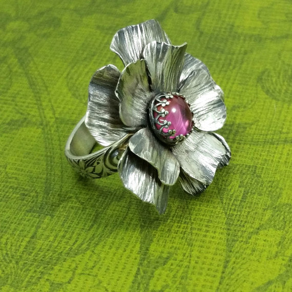 Take a journey to a summer cottage, gracefully adorned with climbing roses, clematis and wisteria. Invoke a feeling of warmth and tranquility with this sterling silver and pink sapphire COTTAGE ROSE Ring.