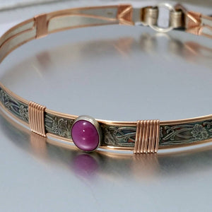 Soft and Sweet artisan collar is hand crafted in a feminine floral pattern of sterling silver and wrapped with luscious rose gold.  A stunning Star Ruby is set in silver. 