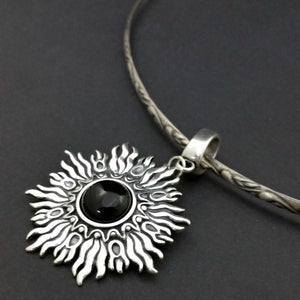 Dramatic Sunburst pendant with hand set with a  gemstone cabochon in your choice of black onyx, carnelian or moonstone. The pendant is sterling silver, the bail is silver plated. Can be worn as a pendant on a chain, or slide onto most all or our artisan collars.
